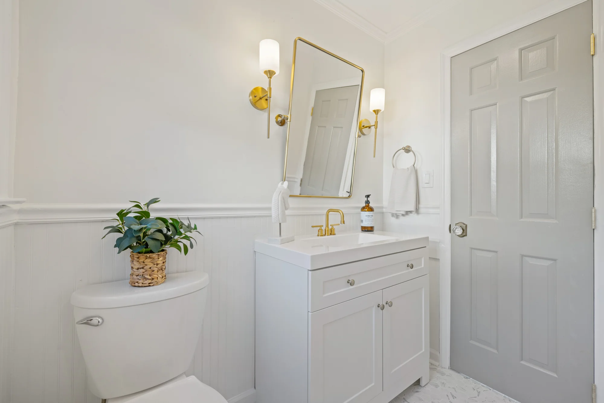 Pemberton: powder room with brass fixtures