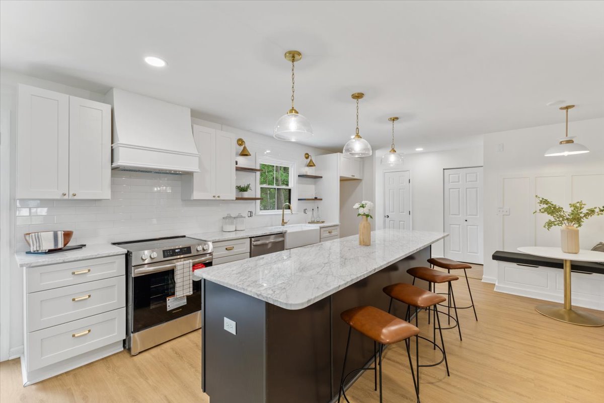 Pepperton: white cabinetry, a dark island, and pendant lighting